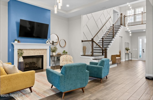 462 Hillendale Cir, Saint Johns, FL 32259 - living room featuring a high ceiling, a fireplace, baseboards, wood finished floors, and stairway