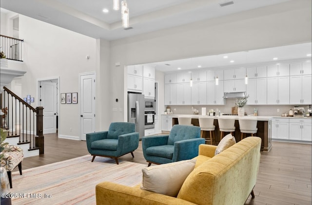 462 Hillendale Cir, Saint Johns, FL 32259 - living area with recessed lighting, a high ceiling, light wood-style flooring, and stairs