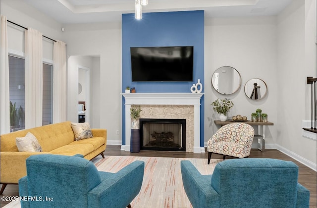 462 Hillendale Cir, Saint Johns, FL 32259 - living area featuring baseboards, wood finished floors, a tray ceiling, and a tile fireplace