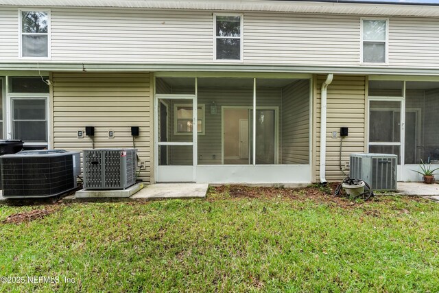 1879 Lago Del Sur Dr, Middleburg, FL 32068 - rear view of house with central AC unit and a sunroom
