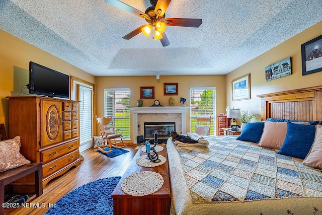 285 Village Green Ave, Saint Johns, FL 32259 - bedroom with wood finished floors, a fireplace, and a textured ceiling