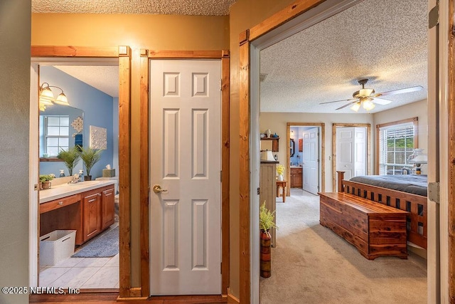 285 Village Green Ave, Saint Johns, FL 32259 - bedroom featuring a textured ceiling, connected bathroom, and light colored carpet