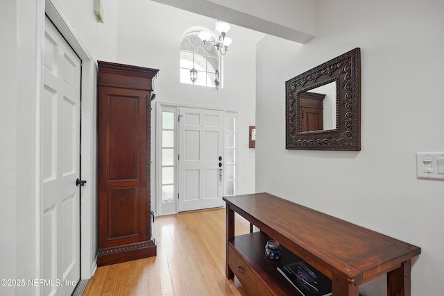 entrance foyer featuring an inviting chandelier and light wood finished floors