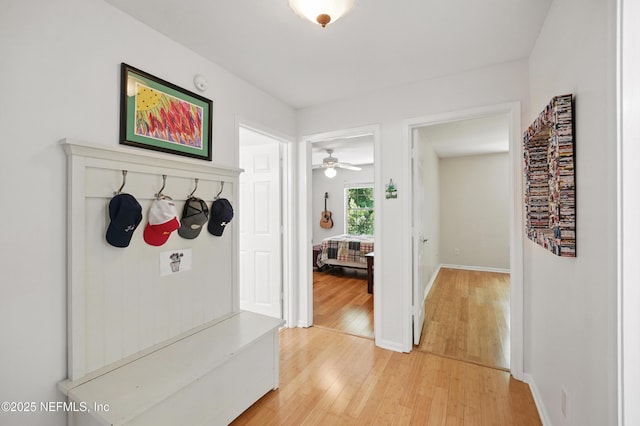 mudroom with baseboards and light wood-style flooring