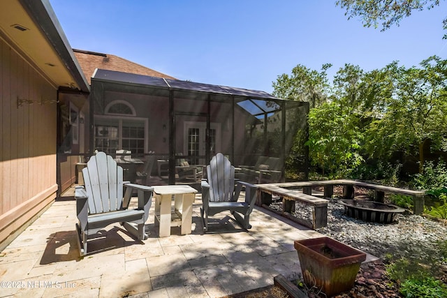 view of patio featuring a lanai