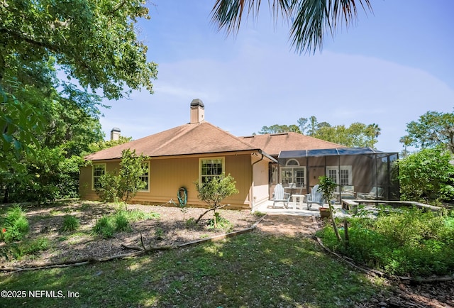 back of property with a patio and a chimney