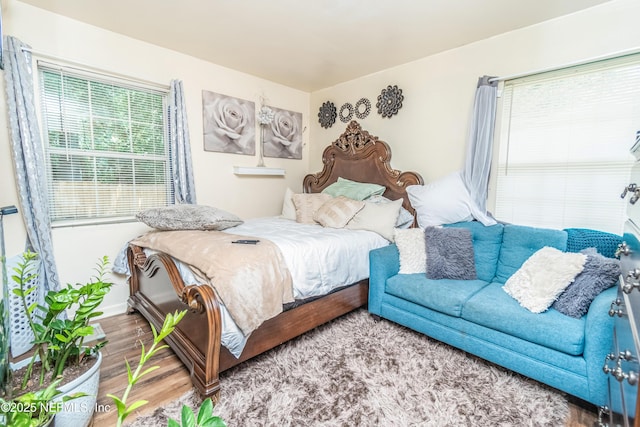 5545 Silverdale Ave, Jacksonville, FL 32209 - bedroom with baseboards, multiple windows, and wood finished floors