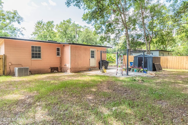 5545 Silverdale Ave, Jacksonville, FL 32209 - back of property with fence, a storage unit, a patio, cooling unit, and an outdoor structure