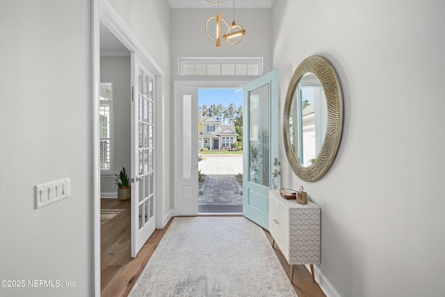 742 Honey Blossom Rd, Saint Johns, FL 32259 - entryway featuring baseboards, ornamental molding, wood finished floors, and an inviting chandelier