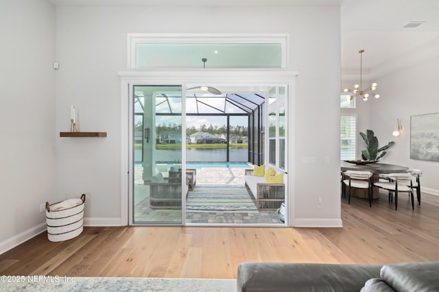 742 Honey Blossom Rd, Saint Johns, FL 32259 - doorway featuring wood finished floors, baseboards, a water view, and a sunroom
