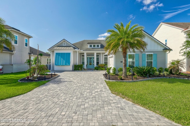 742 Honey Blossom Rd, Saint Johns, FL 32259 - view of front of house with board and batten siding, decorative driveway, and a front yard