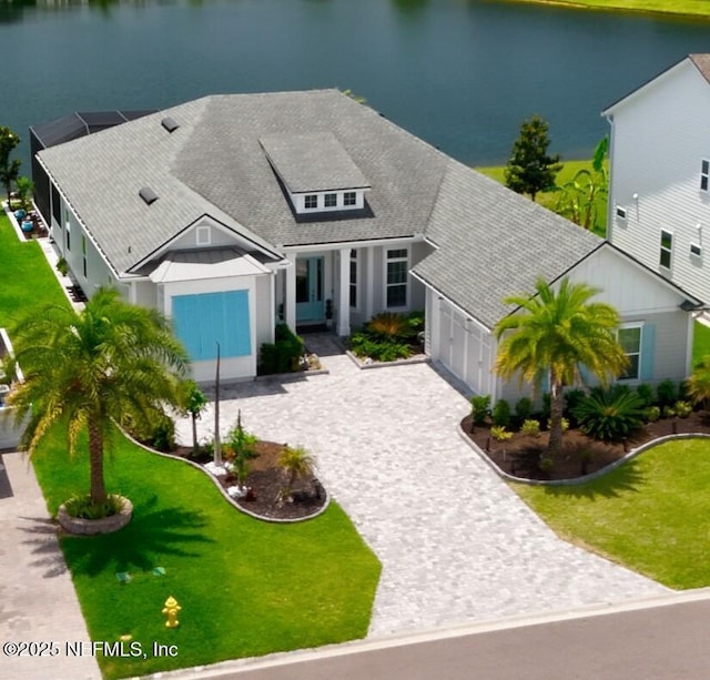 742 Honey Blossom Rd, Saint Johns, FL 32259 - view of front of house with a garage, a front yard, decorative driveway, roof with shingles, and a water view