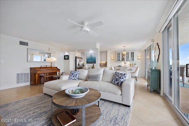 1601 Ocean Dr S Unit 701, Jacksonville Beach, FL 32250 - living room featuring visible vents, light tile patterned floors, and ceiling fan with notable chandelier