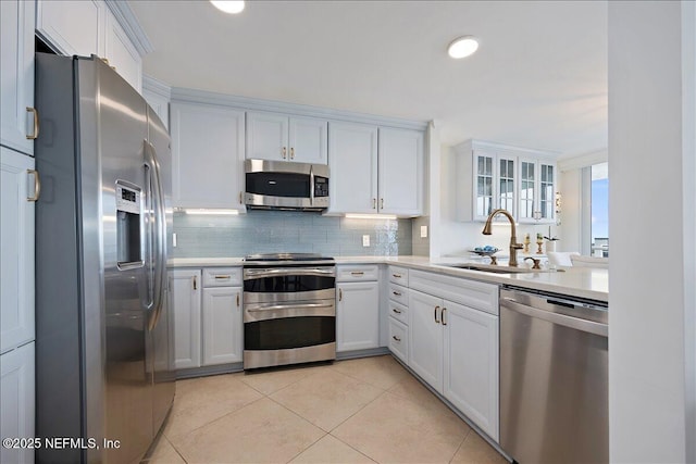 1601 Ocean Dr S Unit 701, Jacksonville Beach, FL 32250 - kitchen featuring a sink, appliances with stainless steel finishes, white cabinets, and light countertops