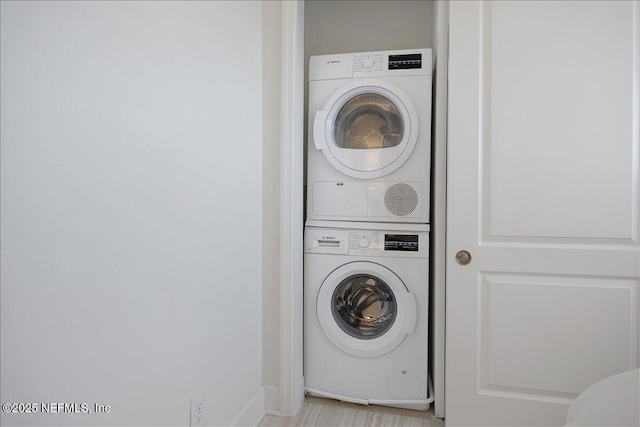 1601 Ocean Dr S Unit 701, Jacksonville Beach, FL 32250 - laundry area featuring baseboards, stacked washer / dryer, and laundry area