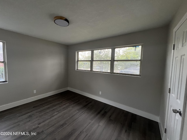 2535 Rogero Rd, Jacksonville, FL 32211 - unfurnished room with baseboards and dark wood-style flooring