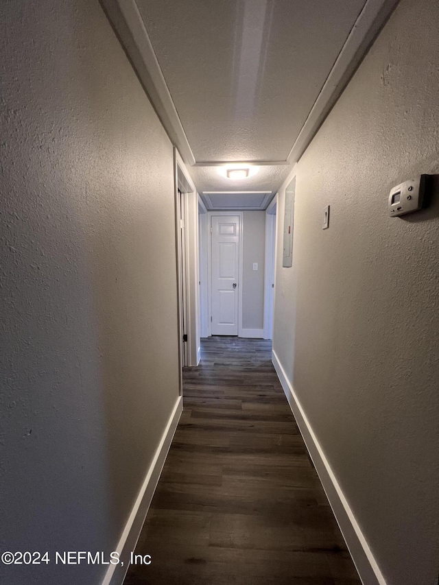 2535 Rogero Rd, Jacksonville, FL 32211 - hall featuring dark wood-style flooring, baseboards, and a textured wall