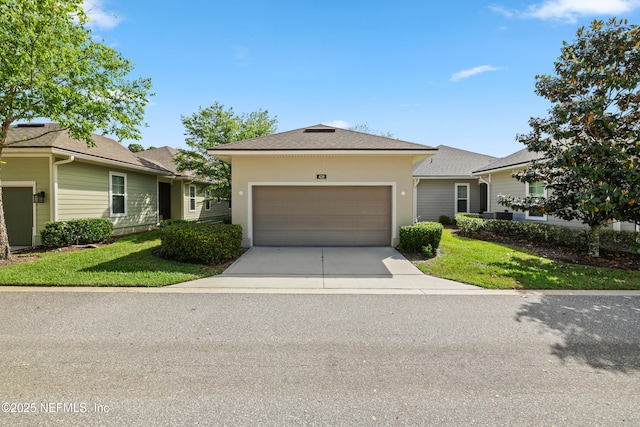 ranch-style house featuring an attached garage, a front lawn, stucco siding, and driveway