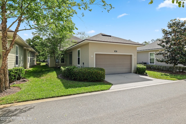 ranch-style home with a garage, a front yard, roof with shingles, stucco siding, and concrete driveway
