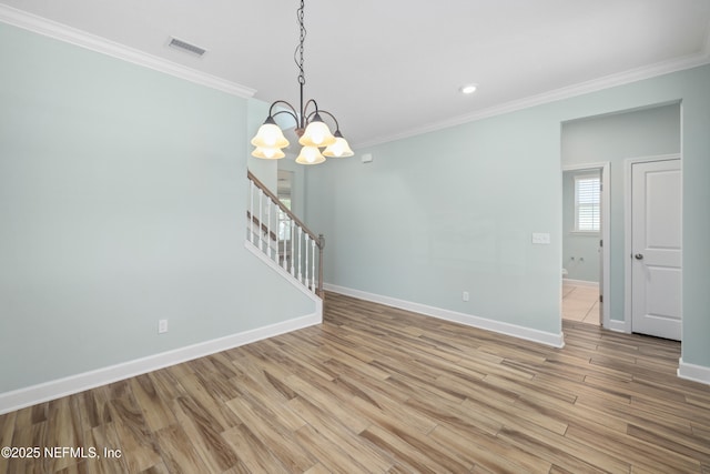 interior space featuring an inviting chandelier, baseboards, ornamental molding, and light wood-style flooring