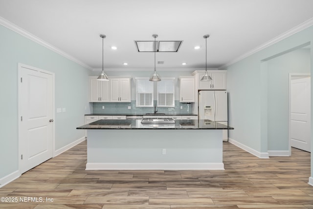kitchen featuring white cabinets, white refrigerator with ice dispenser, and light wood-type flooring