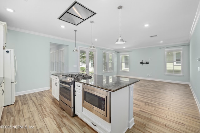 kitchen featuring light wood-type flooring, ornamental molding, and appliances with stainless steel finishes