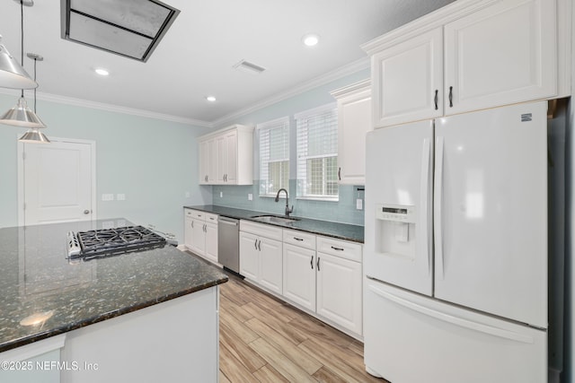 kitchen with a sink, white cabinetry, and white refrigerator with ice dispenser