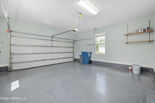 garage featuring baseboards and a garage door opener