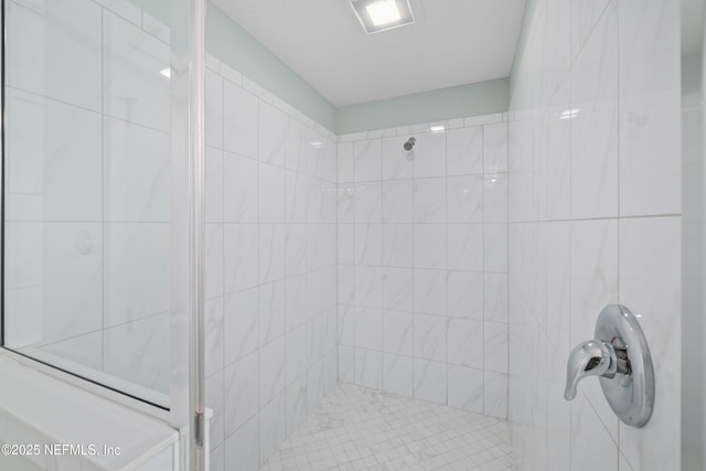 bathroom with tiled shower