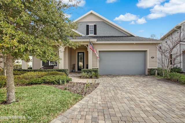 85325 Champlain Dr, Fernandina Beach, FL 32034 - view of front of home with decorative driveway, a garage, and a front lawn