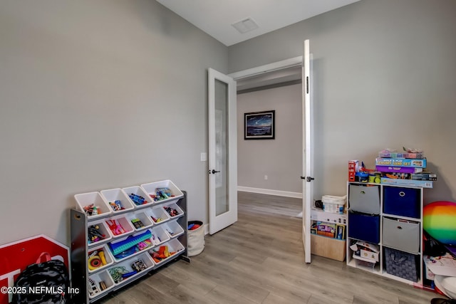 85325 Champlain Dr, Fernandina Beach, FL 32034 - playroom with french doors and wood finished floors
