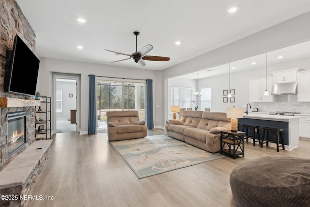 85325 Champlain Dr, Fernandina Beach, FL 32034 - living area featuring a fireplace, a ceiling fan, recessed lighting, light wood-type flooring, and baseboards