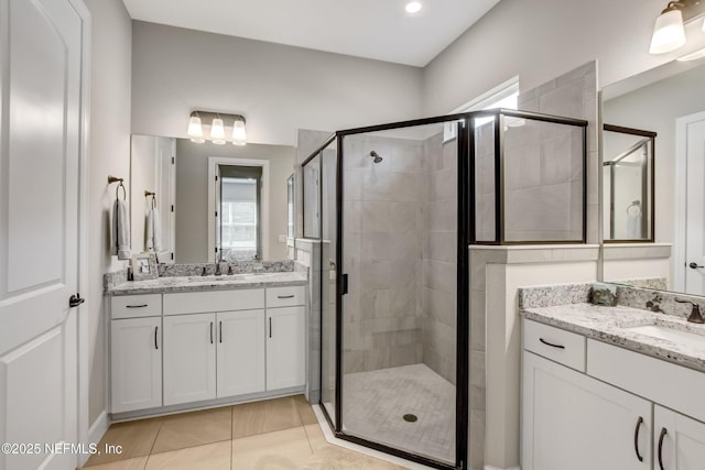 85325 Champlain Dr, Fernandina Beach, FL 32034 - full bathroom featuring a stall shower, two vanities, and tile patterned floors