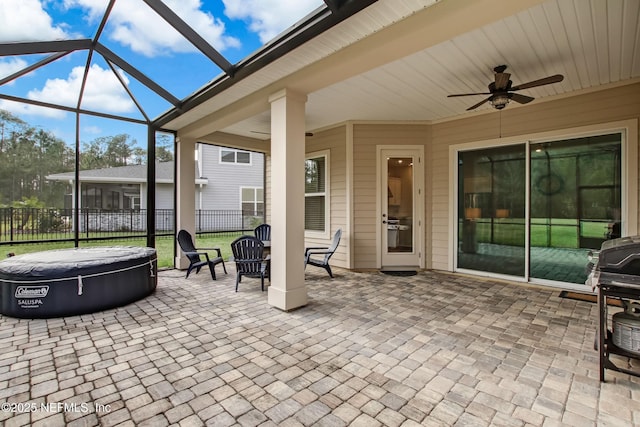 85325 Champlain Dr, Fernandina Beach, FL 32034 - view of patio / terrace featuring ceiling fan, glass enclosure, and a hot tub