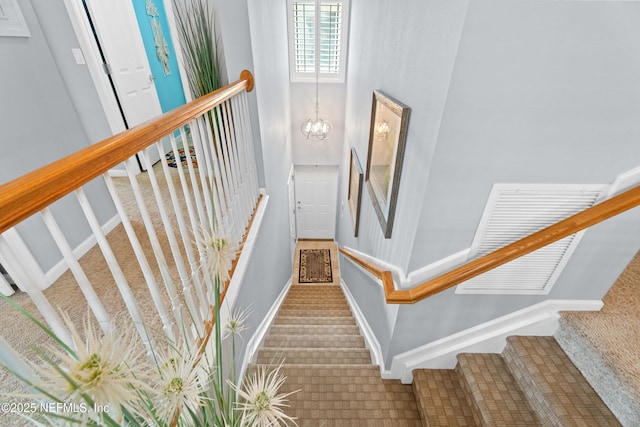 24 Fawn Gully Ln Unit E, Ponte Vedra, FL 32081 - stairway with carpet flooring, baseboards, and a chandelier