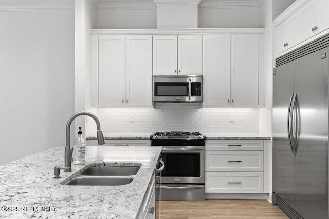 109 Rimini Ct, Jacksonville, FL 32225 - kitchen with stainless steel appliances, a sink, crown molding, white cabinets, and backsplash