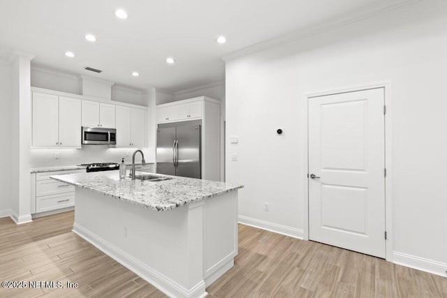 109 Rimini Ct, Jacksonville, FL 32225 - kitchen featuring stainless steel appliances, a sink, crown molding, light wood-type flooring, and white cabinetry