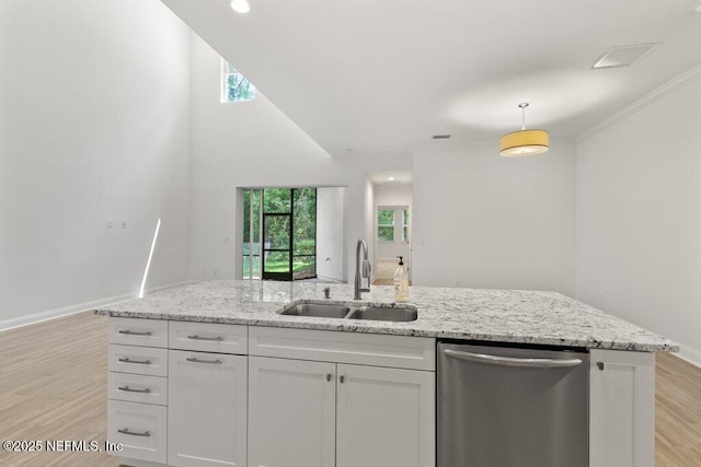 109 Rimini Ct, Jacksonville, FL 32225 - kitchen with stainless steel dishwasher, a sink, white cabinetry, light wood-style flooring, and light stone counters