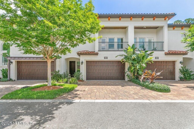 109 Rimini Ct, Jacksonville, FL 32225 - mediterranean / spanish house with a balcony, decorative driveway, a tile roof, and stucco siding