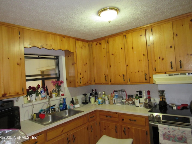 kitchen with a sink, stainless steel range with electric stovetop, light countertops, a textured ceiling, and under cabinet range hood
