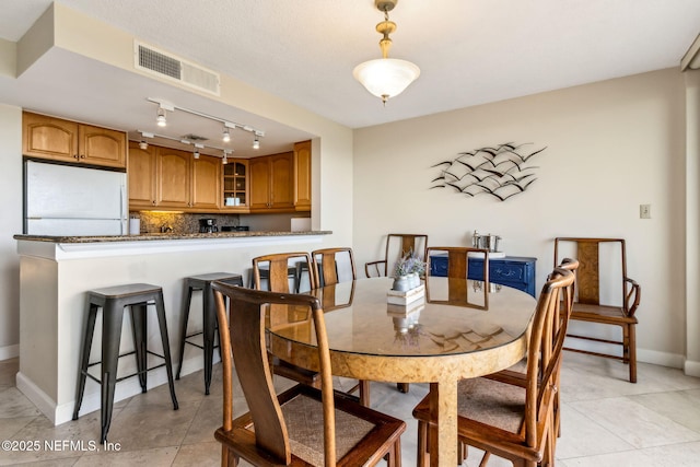 1107 Beach Walker Rd Unit 1107, Amelia Island, FL 32034 - dining area with visible vents, baseboards, light tile patterned floors, and track lighting
