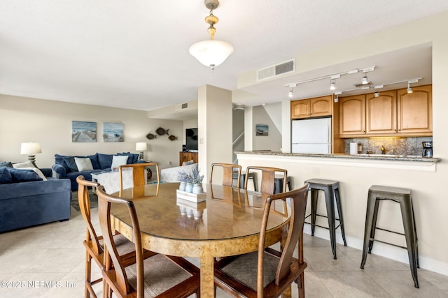 1107 Beach Walker Rd Unit 1107, Amelia Island, FL 32034 - dining room with visible vents, light tile patterned floors, and track lighting