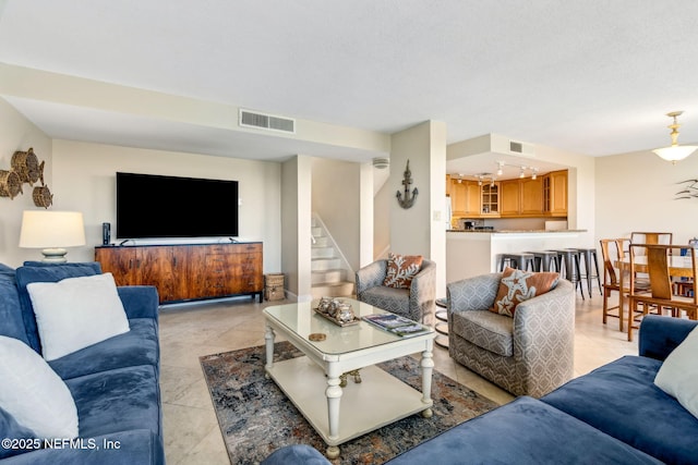 1107 Beach Walker Rd Unit 1107, Amelia Island, FL 32034 - living area featuring visible vents, light tile patterned floors, and stairway