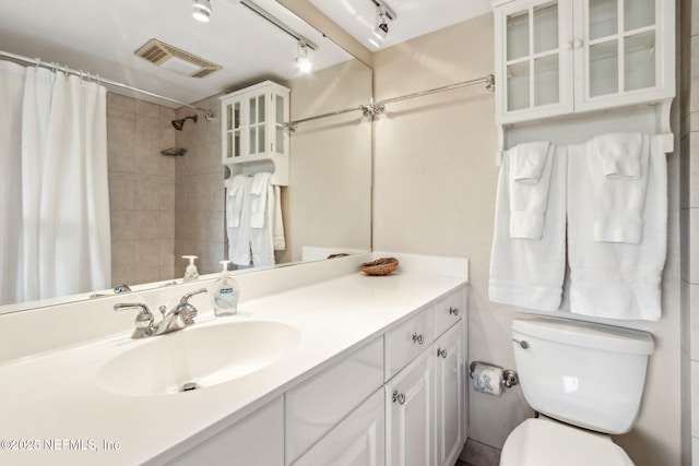 1107 Beach Walker Rd Unit 1107, Amelia Island, FL 32034 - full bathroom with a shower with curtain, visible vents, rail lighting, vanity, and toilet