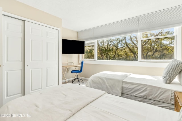 1107 Beach Walker Rd Unit 1107, Amelia Island, FL 32034 - bedroom with a closet, baseboards, and multiple windows