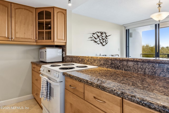 1107 Beach Walker Rd Unit 1107, Amelia Island, FL 32034 - kitchen with baseboards, light tile patterned flooring, white appliances, and glass insert cabinets