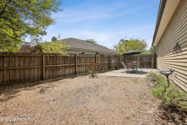 fenced backyard with a patio