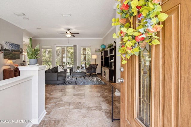 living room with crown molding and ceiling fan