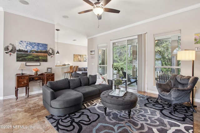living room featuring crown molding, a ceiling fan, and baseboards