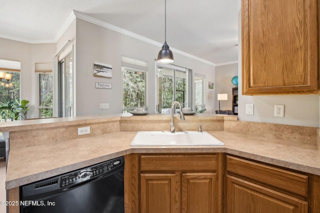 kitchen with dishwasher, a sink, ornamental molding, light countertops, and a peninsula